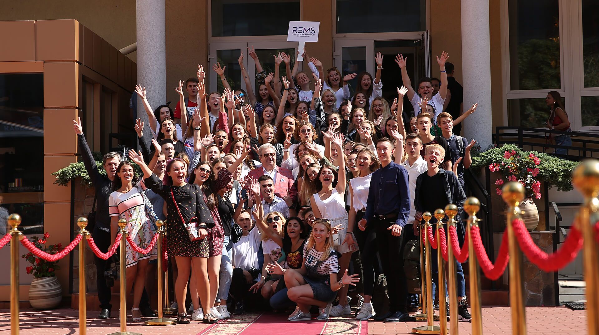 Mykhailo Poplavskyi with students at the entrance to the university of culture